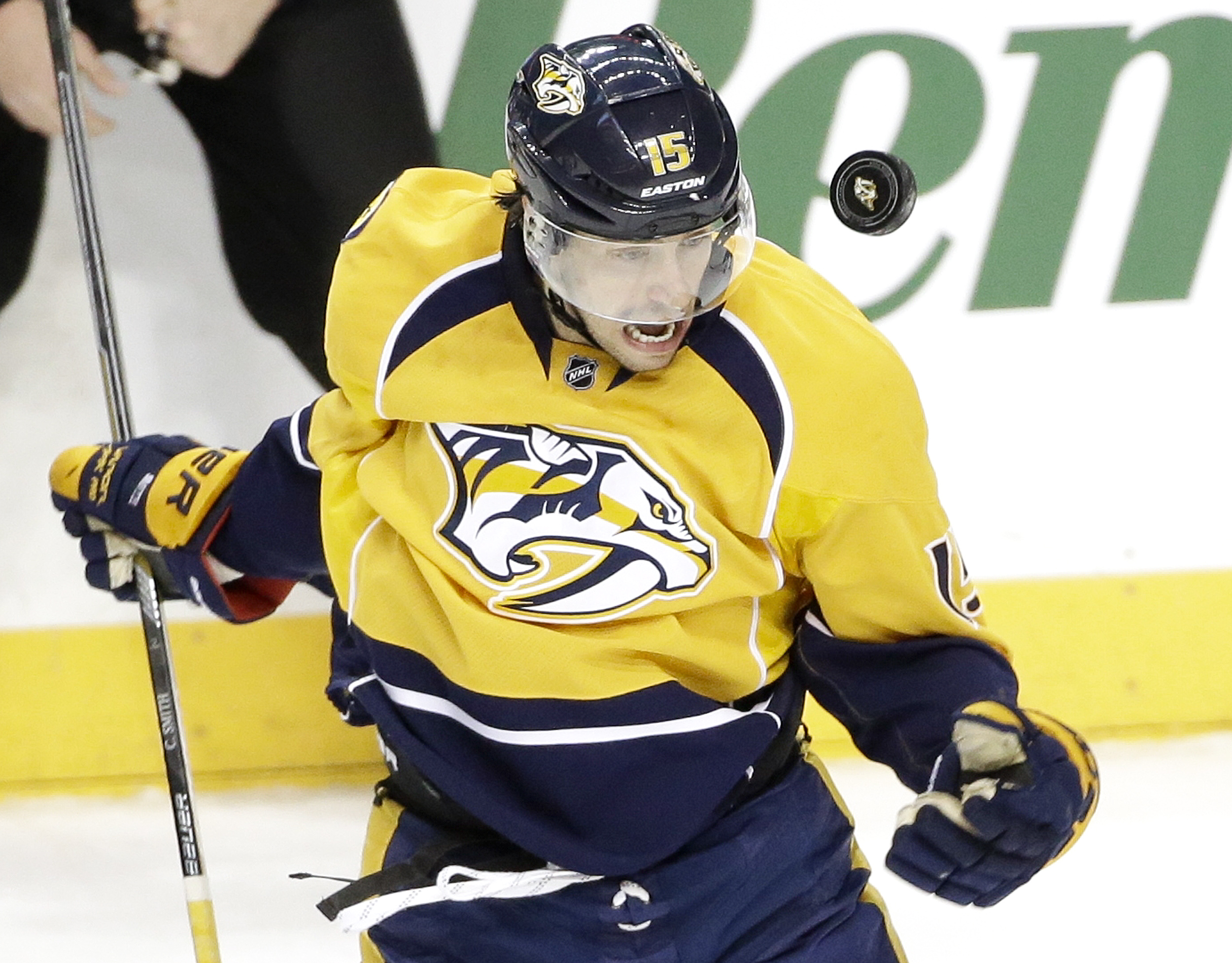 Nashville Predators center Craig Smith tries to control a bouncing puck in the first period of an NHL hockey game against the Detroit Red Wings, Saturday, Feb. 28, 2015, in Nashville, Tenn. (AP Photo/Mark Humphrey)