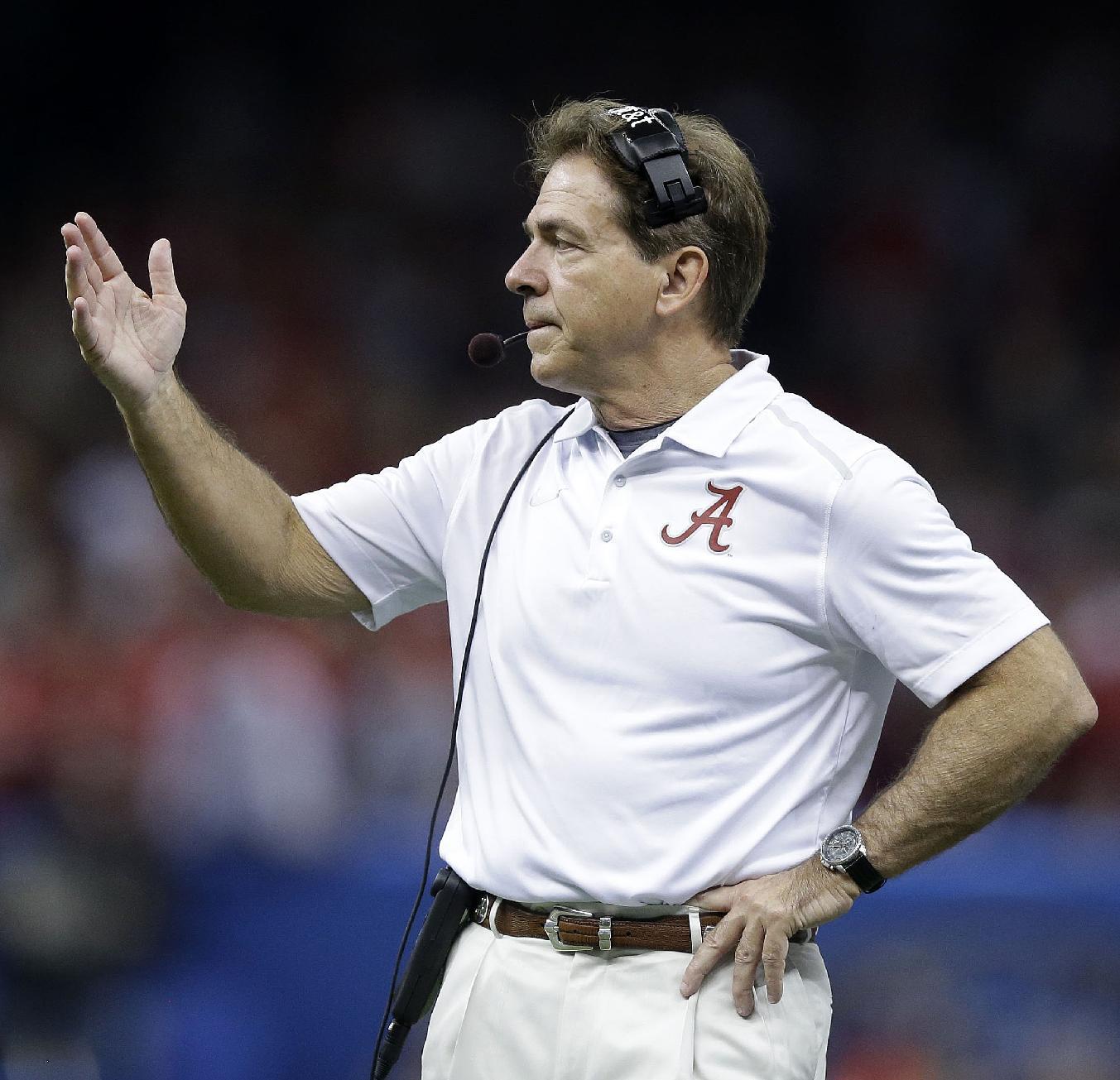 FILE - In this Jan. 1, 2015, file photo, Alabama head coach Nick Saban speaks to his players in the first half of the Sugar Bowl NCAA college football playoff semifinal game against Ohio State in New Orleans. Saban is expected to address the media Monday, March 30, 2015, after two Crimson Tide players were arrested in separate cases over the weekend. Defensive back Geno Smith and defensive lineman Jonathan Taylor are facing legal trouble again.(AP Photo/Brynn Anderson, File)