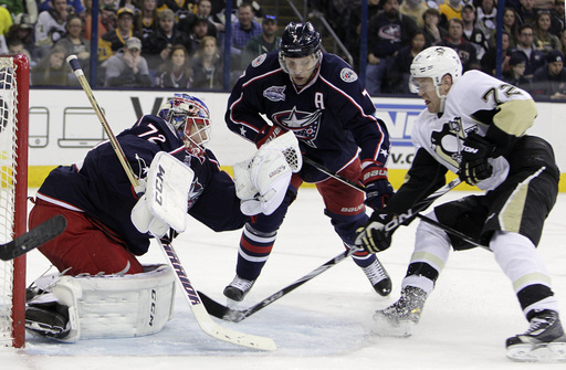 Columbus Blue Jackets' Sergei Bobrovsky, left, of Russia, makes a save as teammate Jack Johnson, center, and Pittsburgh Penguins' Patric Hornqvist, of Sweden, look for the rebound during the third period of an NHL hockey game Saturday, April 4, 2015, in Columbus, Ohio. The Blue Jackets beat the Penguins 5-3. (AP Photo/Jay LaPrete)