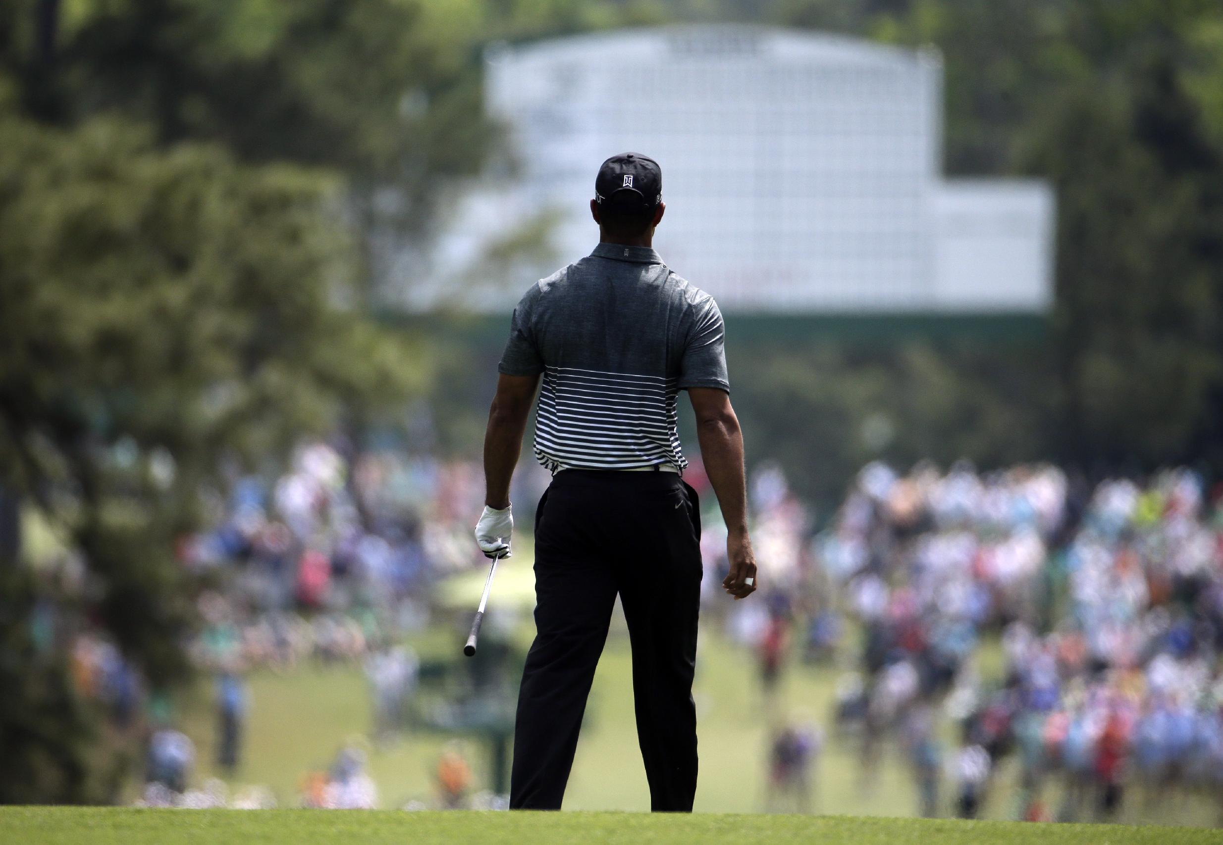Tiger Woods watches his shot on the second fairway during the third round of the Masters golf tournament Saturday, April 11, 2015, in Augusta, Ga. (AP Photo/Charlie Riedel)