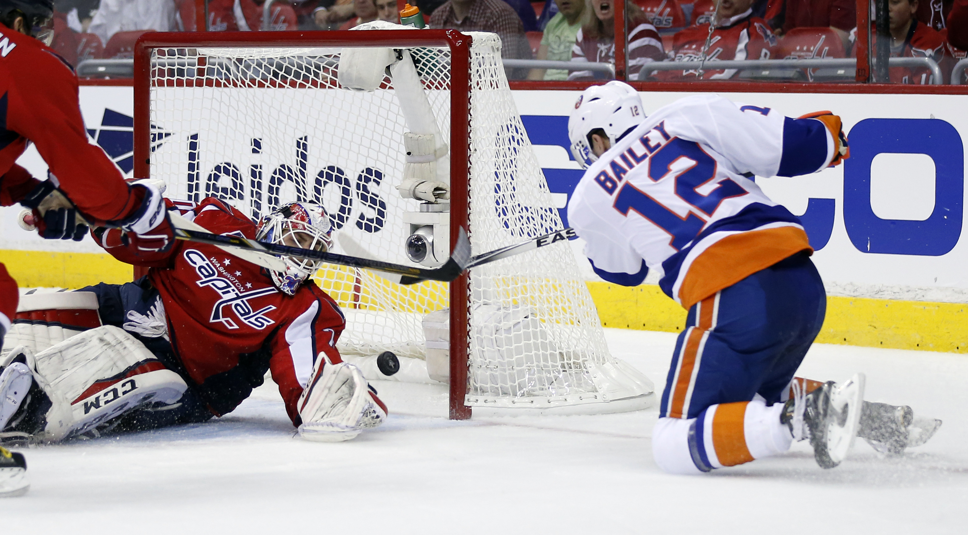 New York Islanders left wing Josh Bailey (12) scores a goal past Washington Capitals goalie Braden Holtby during the second period of Game 1 in a first-round NHL hockey Stanley Cup playoffs series, Wednesday, April 15, 2015, in Washington. (AP Photo/Alex Brandon)