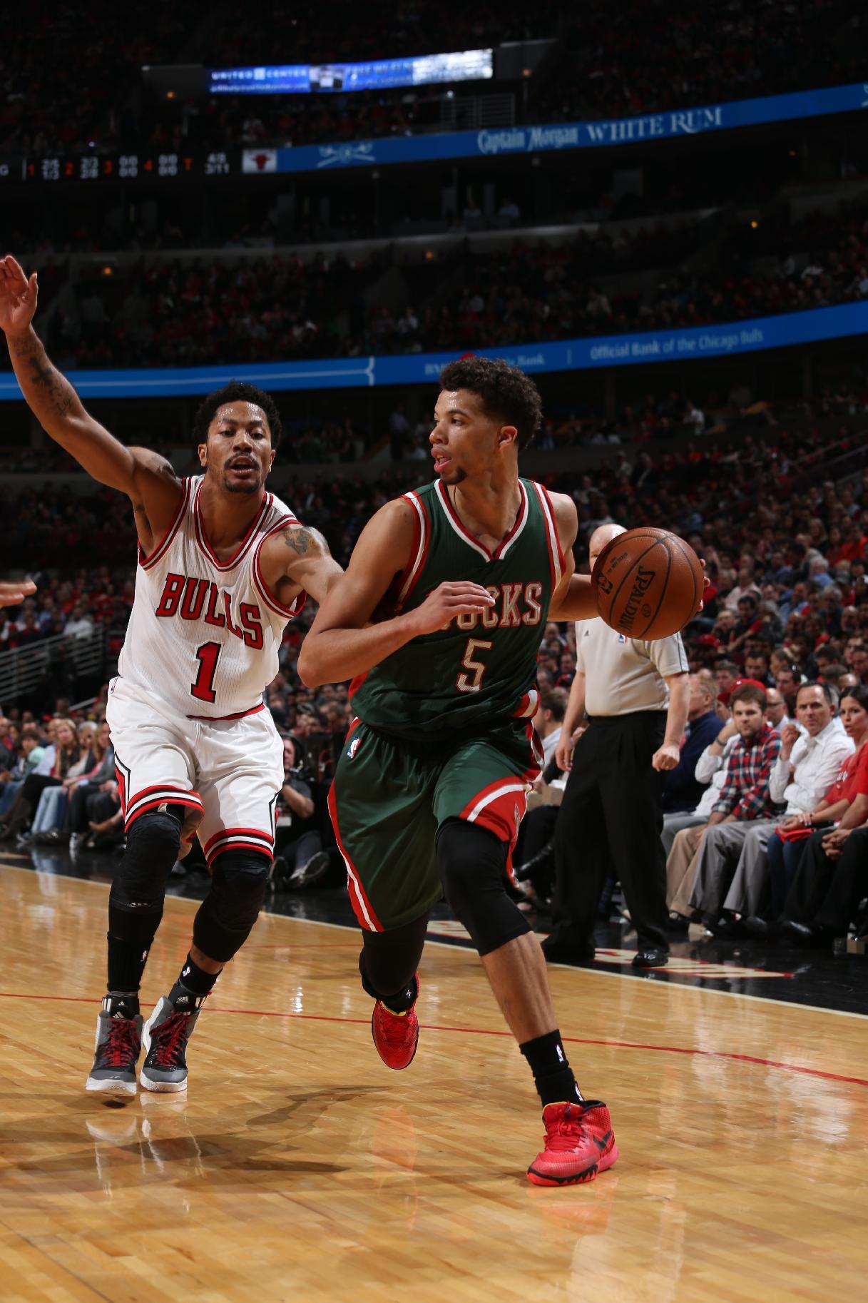 Michael Carter-Williams drives to the basket against Derrick Rose. (Gary Dineen/NBAE/Getty Images)