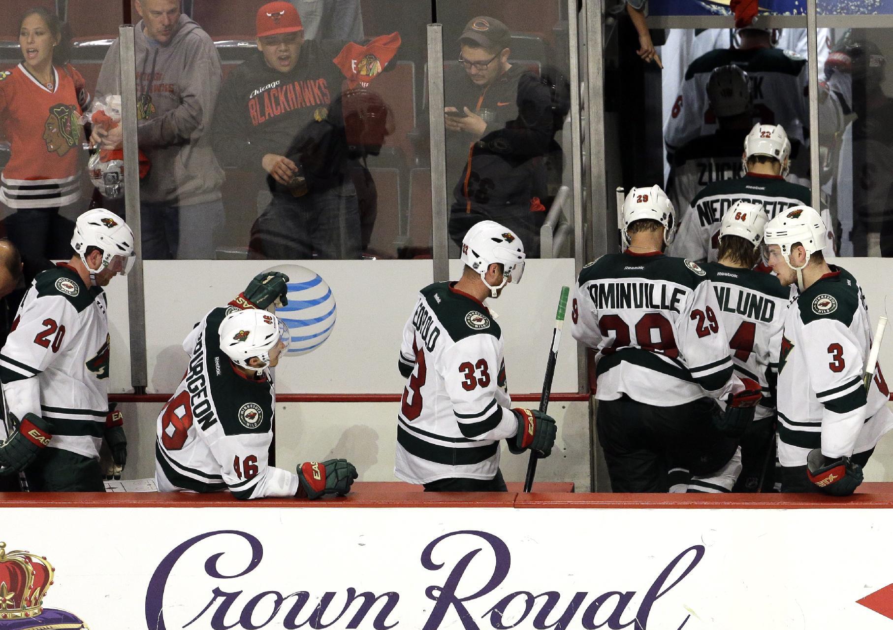 Minnesota Wild players react as they make their way off the ice after a 4-1 loss to the Chicago Blackhawks inGame 2 in the second round of the NHL Stanley Cup hockey playoffs in Chicago, Sunday, May 3, 2015. (AP Photo/Nam Y. Huh)