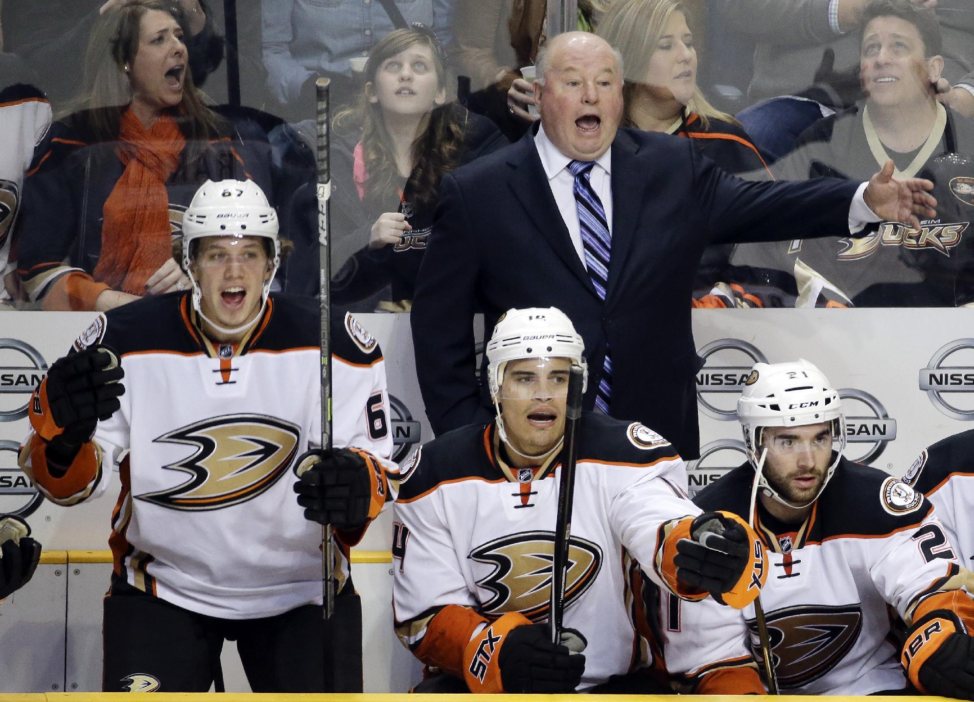 FILE- In this Feb. 5, 2015, file photo, Anaheim Ducks head coach Bruce Boudreau, rear; Rickard Rakell (67), of Sweden; and Rene Bourque (14) yell for a penalty call in the second period of an NHL hockey game against the Nashville Predators in Nashville, Tenn. When the Ducks clinched Boudreau's first trip to the Western Conference finals, the affable coach allowed himself 