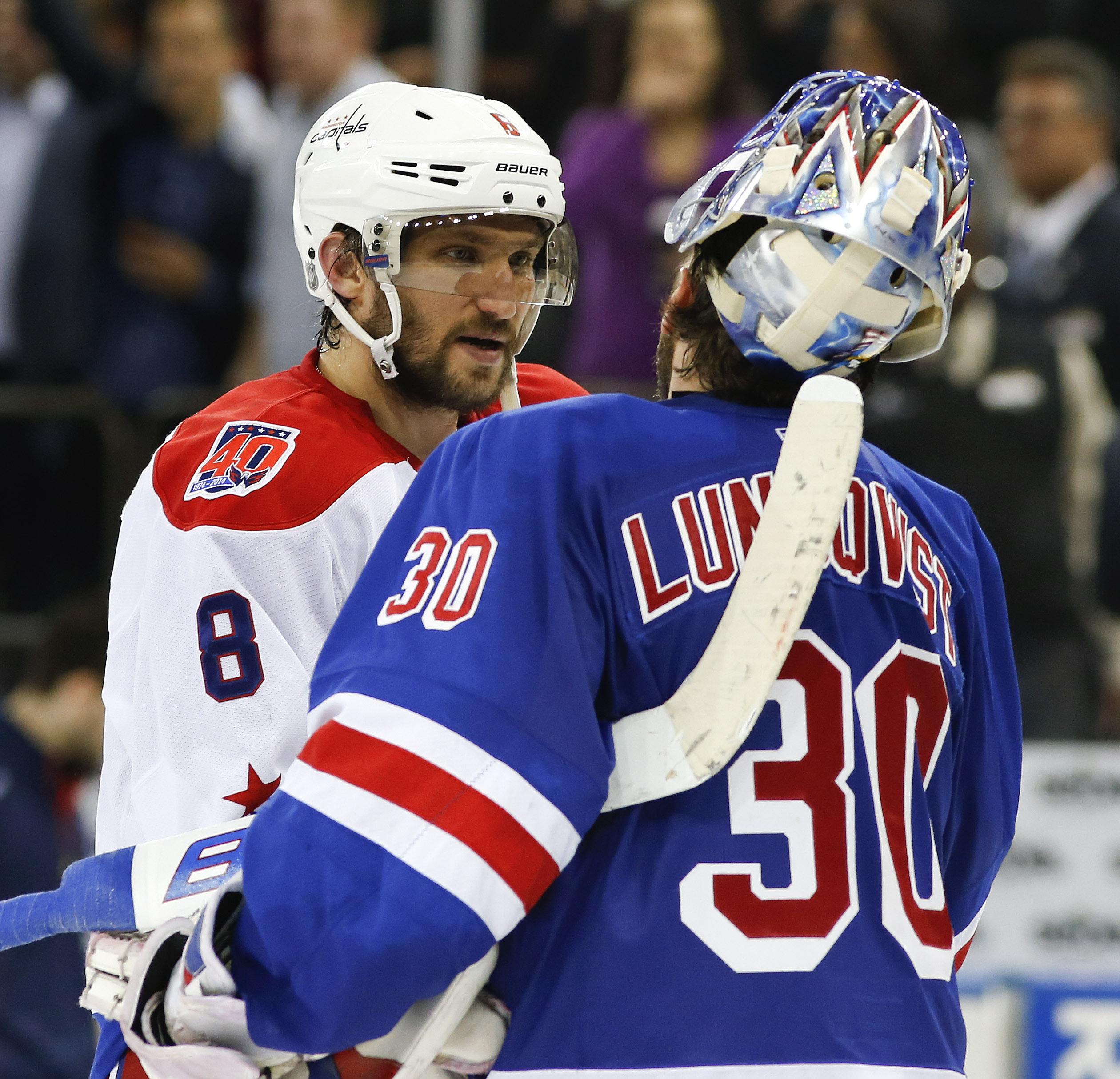 Washington Capitals left wing Alex Ovechkin (8) is greeted by New York Rangers goalie Henrik Lundqvist (30) after the Rangers won 2-1 in overtime in Game 7 of the Eastern Conference semifinals during the NHL hockey Stanley Cup playoffs, Wednesday, May 13, 2015, in New York. (AP Photo/Kathy Willens)