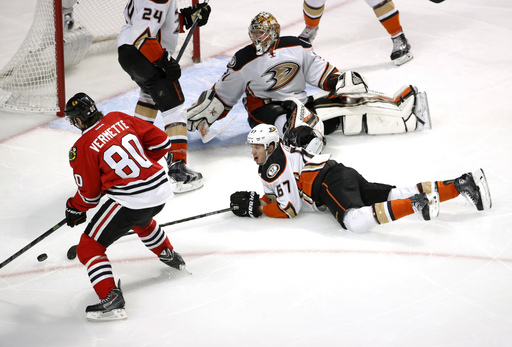 Chicago Blackhawks center Antoine Vermette (80) sets up the winning goal as Anaheim Ducks goalie Frederik Andersen (31) and Anaheim's Rickard Rakell (67) and Simon Despres (24) defend during the second overtime in Game 4 of the Western Conference finals of the NHL hockey Stanley Cup playoffs, Saturday, May 23, 2015, in Chicago. The Blackhawks won 5-4. (AP Photo/Charles Rex Arbogast)