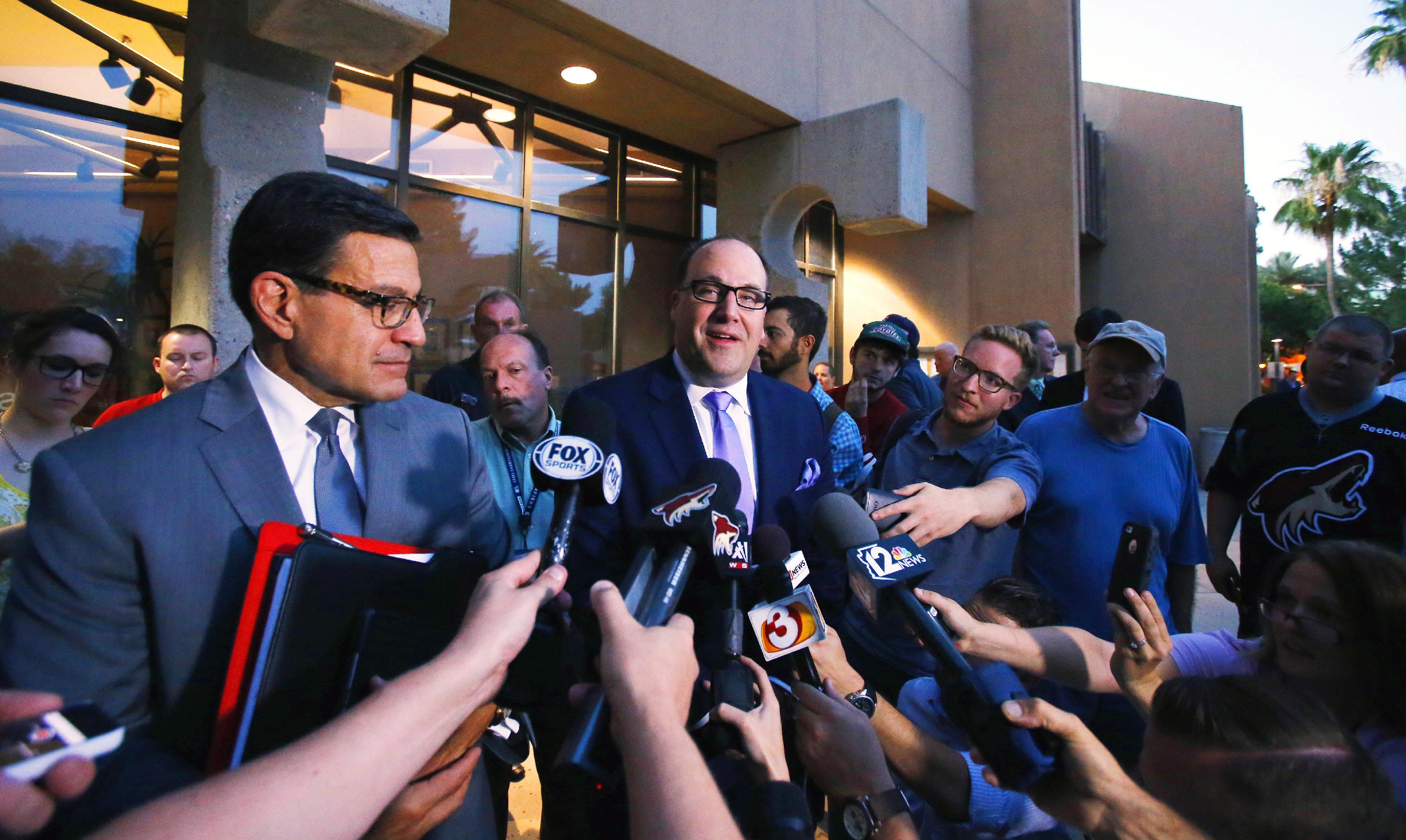 In this photo taken Wednesday, June 10, 2015, Arizona Coyotes attorney Nicholas Wood, left and team president Anthony LeBlanc, center, speak of legal action against the city of Glendale, Ariz. as they speak with the media after the city council voted to back out of an arena leasae agreement with the NHL team during a special council meeting. (David Kadlubowski/The Arizona Republic via AP) MARICOPA COUNTY OUT; MAGS OUT; NO SALES; MANDATORY CREDIT