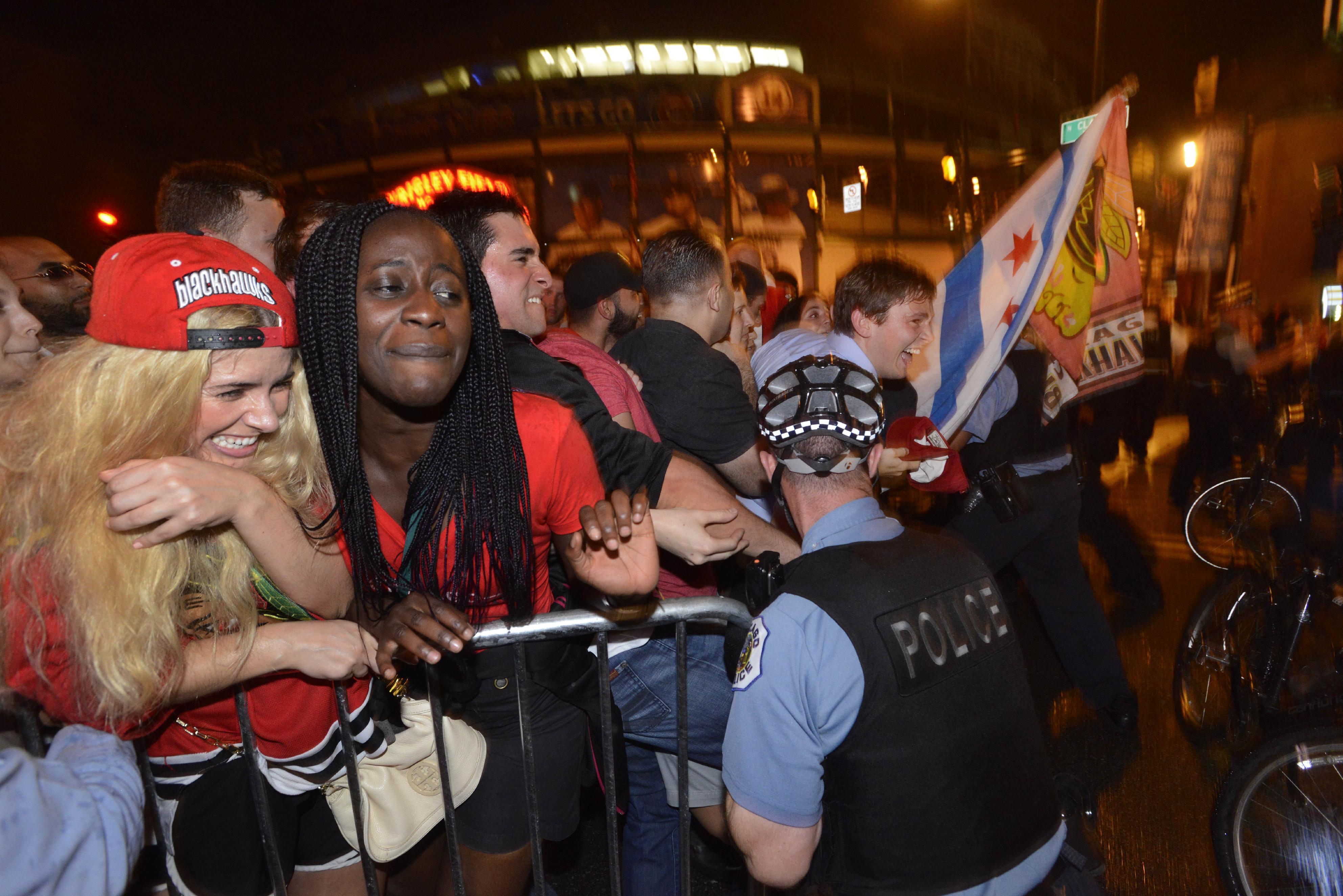 Chicago Blackhawks fans are pushed up against a barricade while celebrating on Clark street in the Wrigleyville neighborhood after the Chicago Blackhawks won the Stanley Cup, defeating the Tampa Bay Lightning in Chicago on Monday, June 15, 2015. (AP Photo/Paul Beaty)