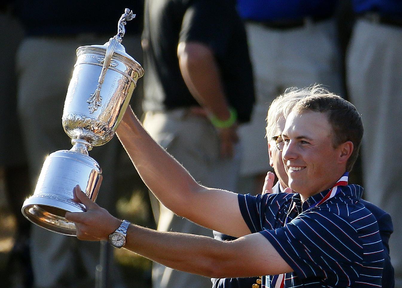 Jordan Spieth holds up the trophy after winning the U.S. Open. (AP)