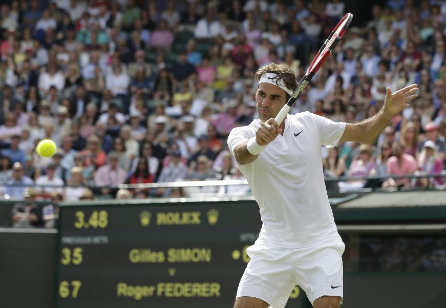 Roger Federer plays a return to Gilles Simon of France. (AP)