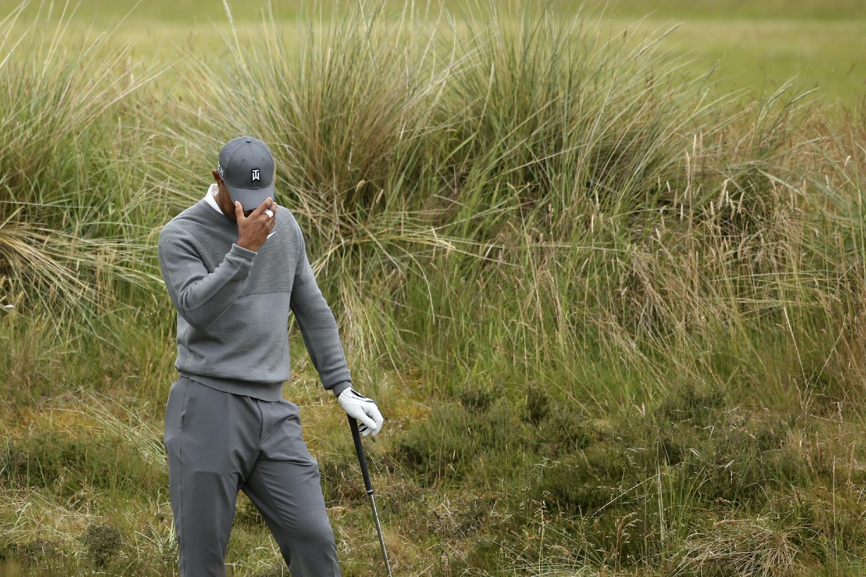 United States' Tiger Woods prepares to take a shot from the rough on the fifth hole during the first round of the British Open Golf Championship at the Old Course, St. Andrews, Scotland, Thursday, July 16, 2015. (AP Photo/Peter Morrison)