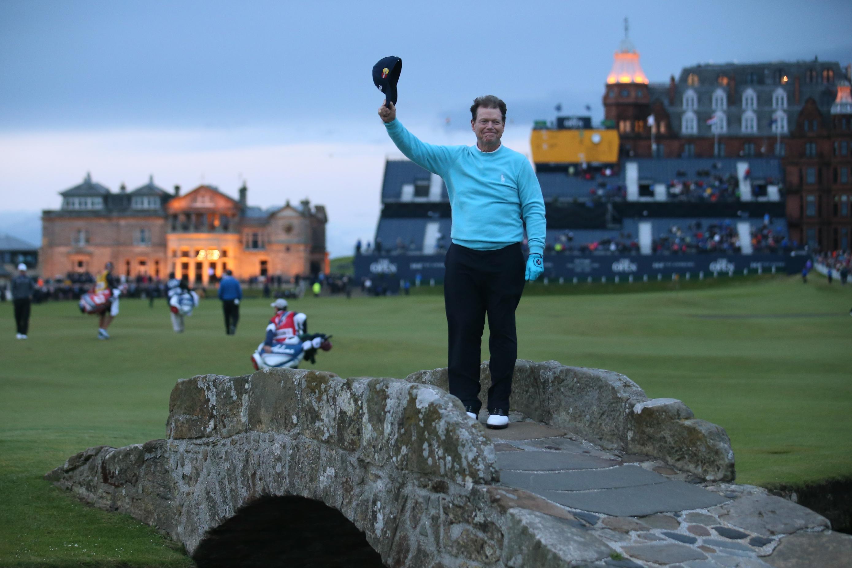 United States' Tom Watson doffs his cap as he poses on the Swilcan Bridge for photographers during the second round of the British Open Golf Championship at the Old Course, St. Andrews, Scotland, Friday, July 17, 2015. (AP Photo/Peter Morrison)