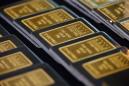 Gold hits near two-week high on dollar weakness, dovish Fed