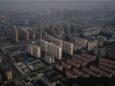 Quarantined Wuhan residents shout words of support out of their high-rise apartment windows