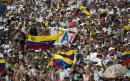 Venezuela's Guaido defies travel ban as aid row turns deadly