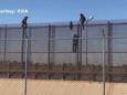 Video shows people climbing fence at border