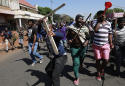 South African attacks on foreign shops continue; 12 dead