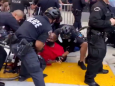 LAPD officers throw black protester from his wheelchair and damage it, video shows
