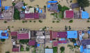 Breached levees trap thousands as flooding in China worsens