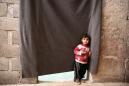 Displaced huddle in a basement as winter grips Syria