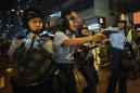 The Latest: HK police draw guns as protesters chase them