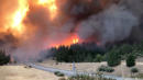 Northern California wildfire threatens homes, closes major highway