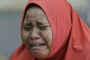 The Latest: Volunteers bury more bodies from Indonesia quake