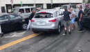 Man with hammer tries to stop driver from fleeing a car crash