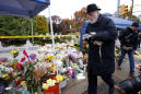 The Latest: Flowers at synagogue honor shooting victims