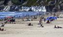 California closes Orange county beaches over Covid-19 fears – but how risky is a beach day?