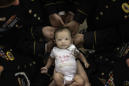 Fallen soldier's comrades cradle his newborn daughter in powerful photo