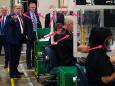 Trump declined to wear a mask at a mask making factory — despite signs displayed that they were required — in a visit that featured music usually played at his campaign rallies